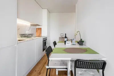 a kitchen with a table and chairs in a room at GuestReady - One Step Closer in Porto