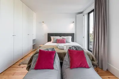 a bedroom with two beds and a couch at GuestReady - One Step Closer in Porto