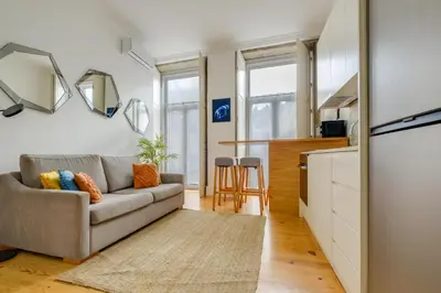 a living room with a couch and a kitchen at Bright 2bedroom apartment in Bonfim, 2 minutes from Campanhã, Porto city center in Porto