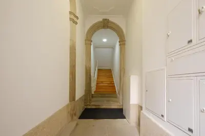 a hallway with an archway and stairs in a building at Bright 2bedroom apartment in Bonfim, 2 minutes from Campanhã, Porto city center in Porto