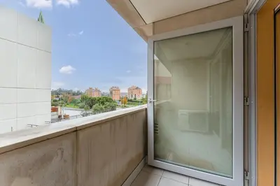 a glass balcony with a view of the city at GuestReady - Cosy Studio Near Arrábida Shopping in Vila Nova de Gaia