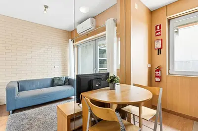 a living room with a table and a couch at GuestReady - Cosy Studio Near Arrábida Shopping in Vila Nova de Gaia