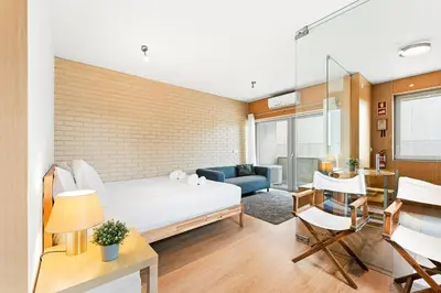 a bedroom with a bed and a living room at GuestReady - Cosy Studio Near Arrábida Shopping in Vila Nova de Gaia