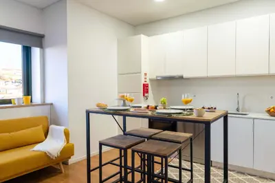 a kitchen with a table and a yellow couch at Colorful & Cozy Apartment by HostWise in Porto