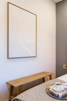 a picture hanging on a wall next to a table at Colorful & Cozy Apartment by HostWise in Porto