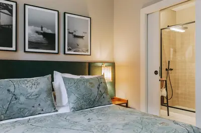 a bedroom with a bed and pictures on the wall at Gran Cruz Apartments in Vila Nova de Gaia