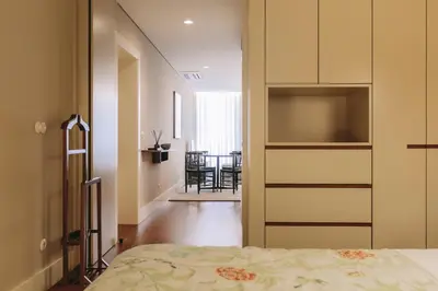 a bedroom with a bed and a dining room at Gran Cruz Apartments in Vila Nova de Gaia