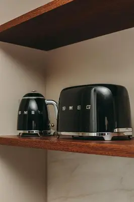 two toaster and toasters sitting on a shelf at Gran Cruz Apartments in Vila Nova de Gaia