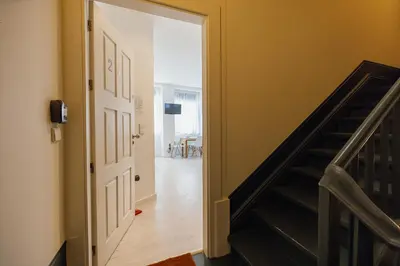 an open door leading to a hallway with a staircase at Downtown Formosa Studio by Vacationy in Porto