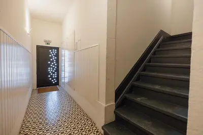 a hallway with stairs leading to a door at Downtown Formosa Studio by Vacationy in Porto