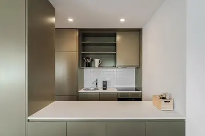 a bedroom with a bed and a table and a kitchen at Bom Sucesso Executive Flats by Feel Porto in Porto