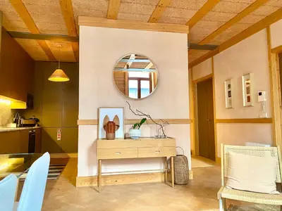 a living room with a table and a mirror at Paraíso Garden Apartments in Porto