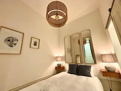 a bedroom with a bed and a pendant light at Paraíso Garden Apartments in Porto