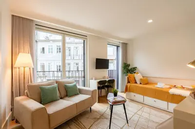 a living room with a couch and a table at Stylish Formosa Studio by HostWise in Porto