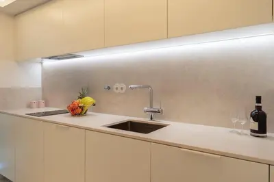a kitchen counter with a sink and a bottle of wine at Stylish Formosa Studio by HostWise in Porto