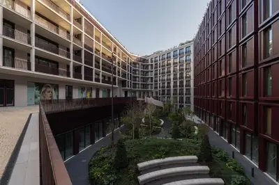 an apartment building with a garden in a courtyard at Stylish Formosa Studio by HostWise in Porto