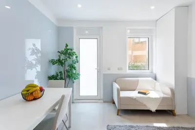 a living room with a white couch and a chair at Authentic Retreat by HostWise in Porto