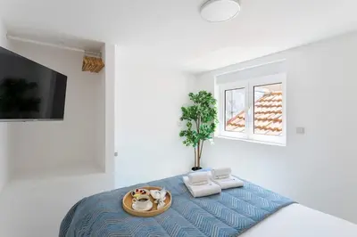 a room with a bed with a tray of food on it at Authentic Retreat by HostWise in Porto