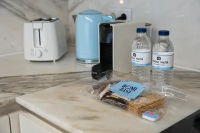 a kitchen counter with two bottles of water and bread at Historic Porto Flat, Central Porto in Porto