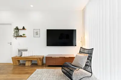 a living room with a chair and a table at Historic Porto Flat, Central Porto in Porto