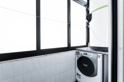 a washing machine in a bathroom with windows at GuestReady - Charming retreat in Porto in Porto