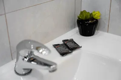a bathroom sink with a faucet and two toothbrushes at GuestReady - Charming retreat in Porto in Porto