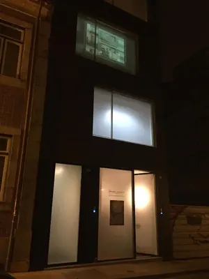 a building with three windows on the side at night at Miguel Bombarda - Porto Houses & Suites in Porto