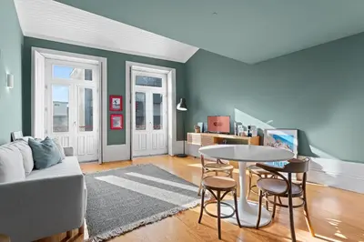 a living room with a couch and a table at GuestReady-Cozy Duplex in Porto's Vibrant Heart in Porto