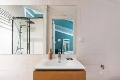 a bathroom with a sink and a mirror at GuestReady-Cozy Duplex in Porto's Vibrant Heart in Porto