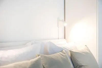 a white bed with white pillows on it at GuestReady - Charming Studio in Porto Centre in Porto