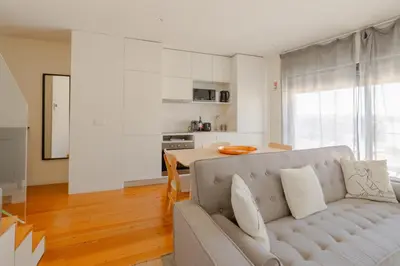 a living room with a couch and a table at Trindade Skyline Premium by Hosty in Porto