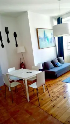 a living room with a white table and chairs at Historical Porto Apartment in Porto