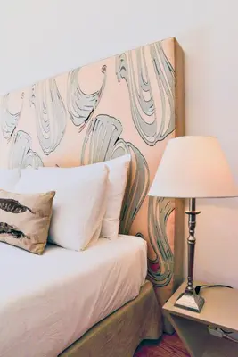 a bedroom with a bed with a painting on the wall at Studio Palazzo, Antique Charm with Romantic Balcony and AC in Porto