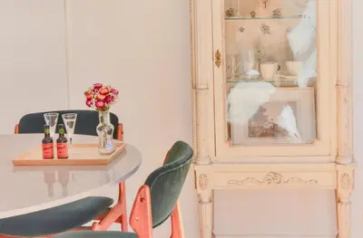a dining room with a table and chairs and a picture at Studio Palazzo, Antique Charm with Romantic Balcony and AC in Porto