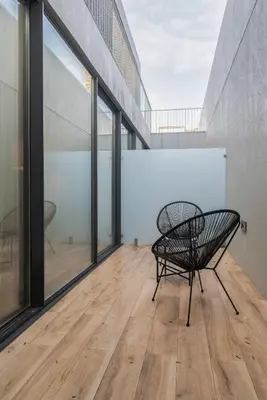 a bench sitting on a wooden floor in a room with windows at Liiiving in Porto - The Prestige Apartment C in Porto