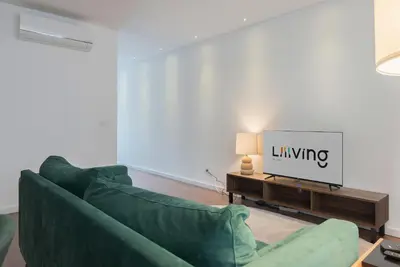 a bedroom with a large bed with blue pillows at Liiiving in Porto - The Prestige Apartment C in Porto