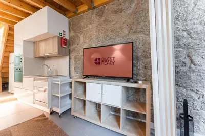a kitchen with a flat screen tv on a counter at GuestReady - charming retreat in Porto in Porto