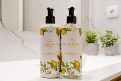 two bottles of shampoo sitting on a bathroom counter at Luxury Style 8 with AC Downtown Porto near Metro in Porto