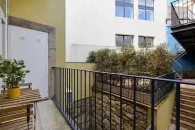 a balcony with a gate and benches and a building at Luxury Style 8 with AC Downtown Porto near Metro in Porto