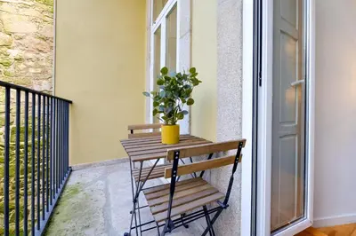 a bench on a balcony with a potted plant at Luxury Style 8 with AC Downtown Porto near Metro in Porto