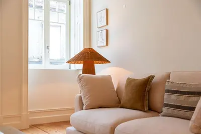 a living room with a couch and a lamp at Almada 559 - Eça Atelier by Lisbeyond in Porto