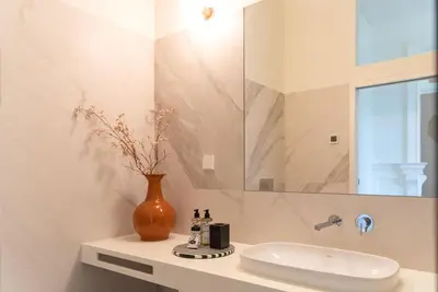 a bathroom with a sink and a vase on a counter at Almada 559 - Ortigão Residence by Lisbeyond in Porto