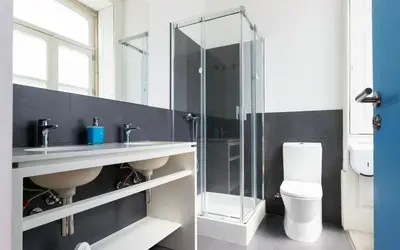 a bathroom with a glass shower and a toilet at Best Guest Porto Hostel in Porto