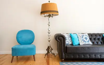 a living room with a black couch and a blue chair at Best Guest Porto Hostel in Porto