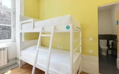 a bedroom with two bunk beds in a room at Best Guest Porto Hostel in Porto