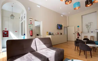 a living room with a couch and a table at Best Guest Porto Hostel in Porto