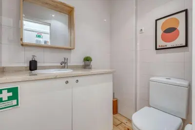 a bathroom with a toilet and a sink and a mirror at OPORTO GUEST Alegria126 in Porto