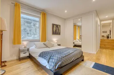 a bedroom with a bed and a large window at OPORTO GUEST Alegria126 in Porto