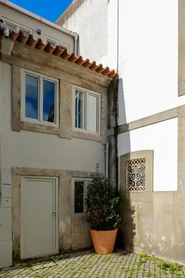 an old church with cars parked in front of it at The Riverside House in Porto