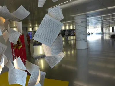 a bunch of papers hanging on a wall in a building at Carolina M Apartment in front of Metro in Porto